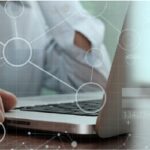 hand on laptop, working with database migration tools