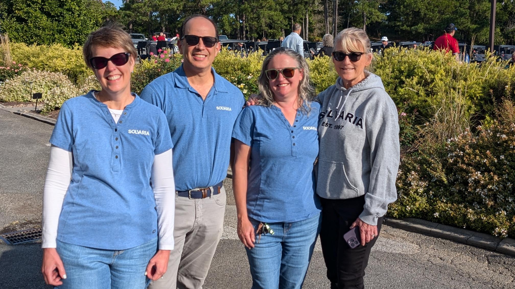 Four team members in Solvaria shirts