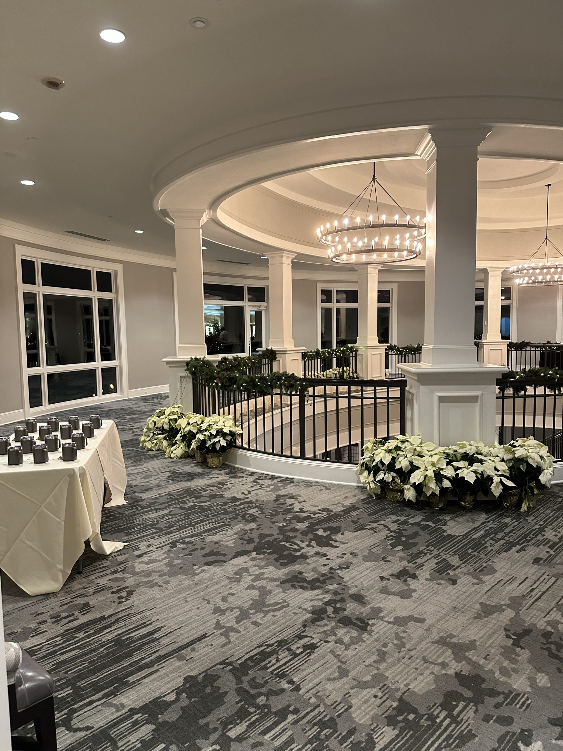 A spacious circular room filled with tables and chairs for gatherings and meetings.