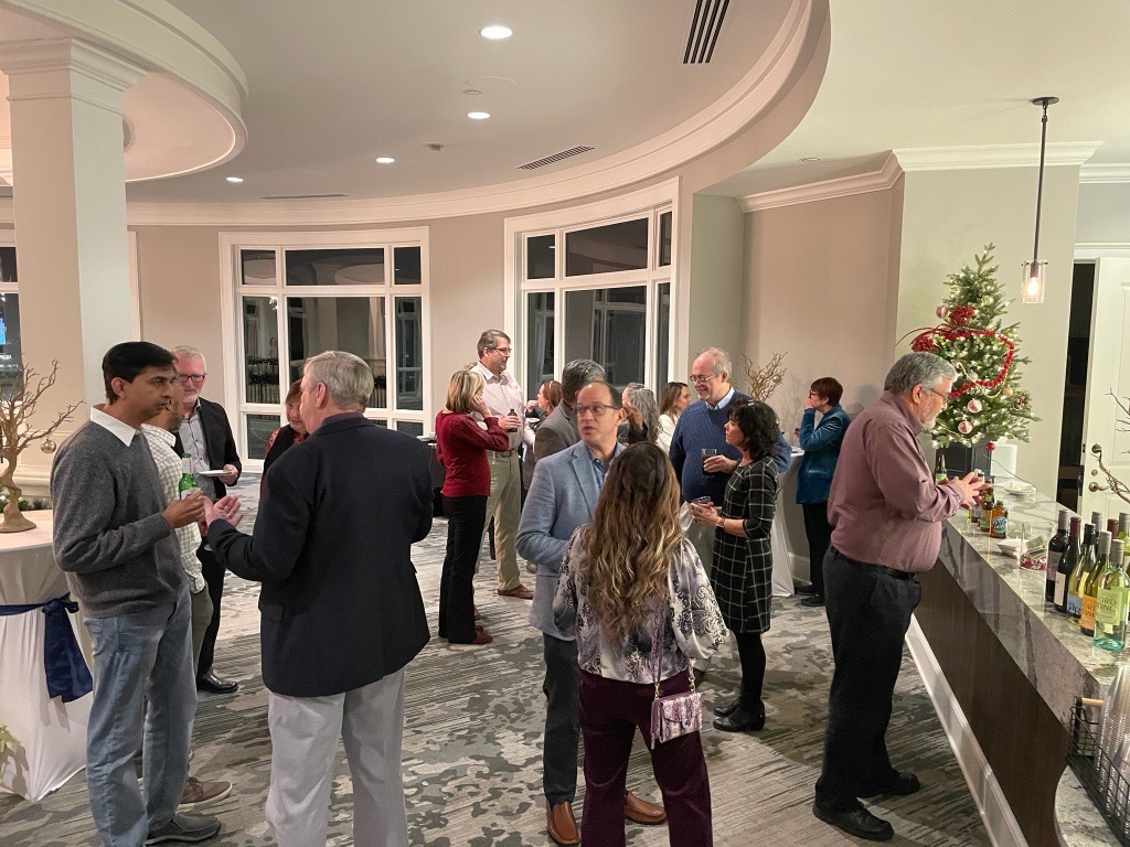 Guests mingling around a table during a festive gathering.
