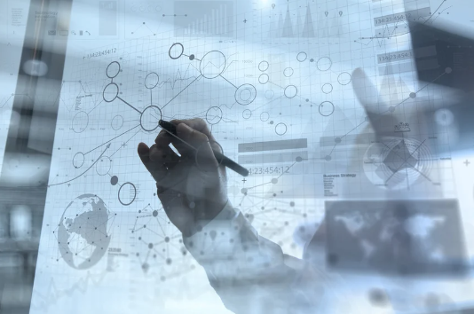 A person draws interconnected lines and circles on a transparent digital screen displaying graphs, charts, and a world map, suggesting data analysis, SQL Server performance tuning, and global business strategy.