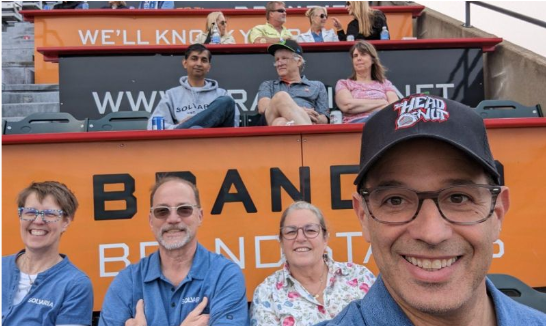 Crowd seated in the stands at a baseball stadium.