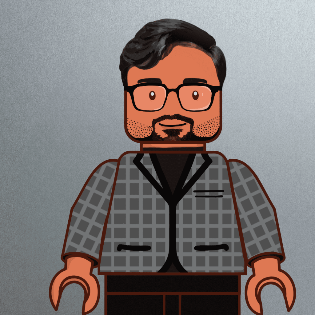 A LEGO-style figure resembling Sunny Goswami, with brown skin, black hair, glasses, and a trimmed beard, wearing a gray checkered jacket over a black shirt, stands against a plain gray background.