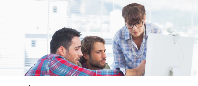 Team of designers working together on a computer