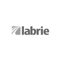 The image shows the word labrie in lowercase gray letters next to a gray square with curved white lines extending from the lower left corner, resembling stylized roads or paths. The background is white.